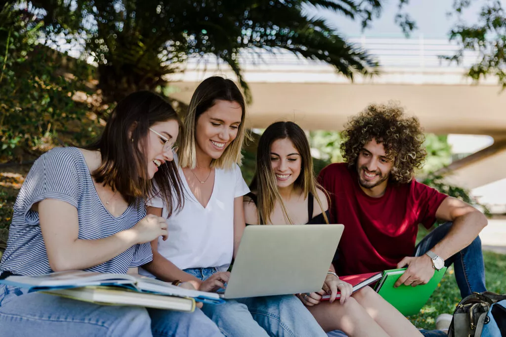 students-using-laptop-in-park-1024x682